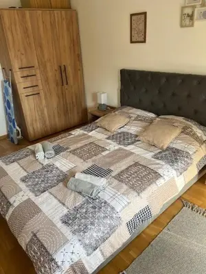 a bed with a quilt on it in a bedroom at Apartman Moj kutak 29 in Vrnjačka Banja
