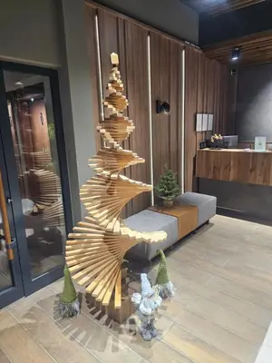 a wooden spiral christmas tree in a lobby at Nest 316 Bela Reka Kopaonik in Brzeće