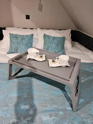 a coffee table in front of a bed at Nest 316 Bela Reka Kopaonik in Brzeće