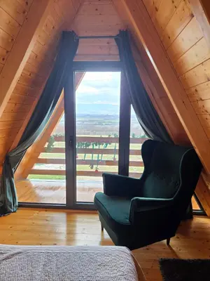 a chair in a room with a large window at Vezirove zore in Paraćin