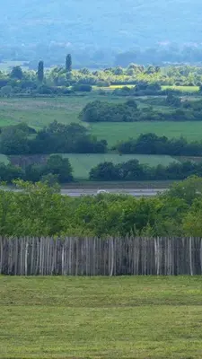 a wooden fence in a field next to a field at Vezirove zore in Paraćin