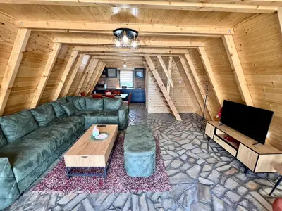 a living room with a leather couch and a table at Vezirove zore in Paraćin
