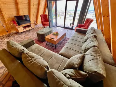 a living room with a large couch and a television at Vezirove zore in Paraćin