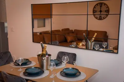 a dining room table with plates and wine glasses at Sunčani Horizonti in Soko Banja