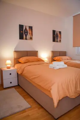 two beds sitting next to each other in a bedroom at Sunčani Horizonti in Soko Banja
