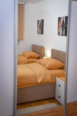 a bedroom with two beds and a mirror at Sunčani Horizonti in Soko Banja