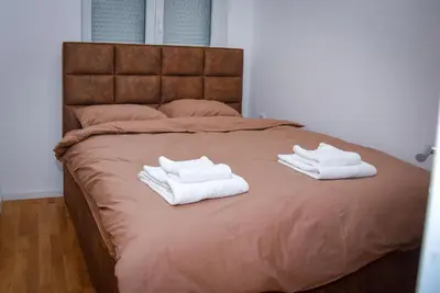 two white towels sitting on top of a bed at Sunčani Horizonti in Soko Banja
