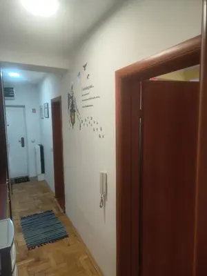 a hallway with a door to a room with a wall at Agape in Niš