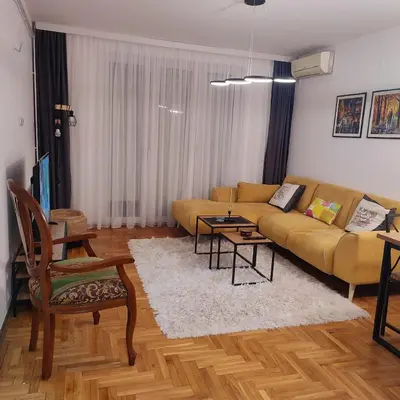 a living room with a couch and a table at Banjski apartman in Vrnjačka Banja