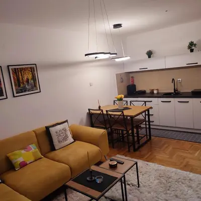 a living room with a couch and a table at Banjski apartman in Vrnjačka Banja