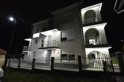 a white building with balconies at night at VILA RUŽA - Grand apartman 1 in Soko Banja