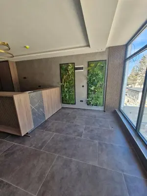 a large room with a large tile floor and windows at RELAX RESIDENS-kopaonik in Kopaonik
