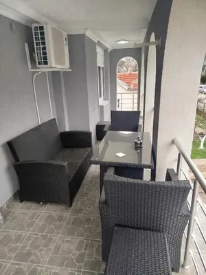 a balcony with a table and chairs on a porch at VILA RUŽA - Grand apartman 2 in Soko Banja