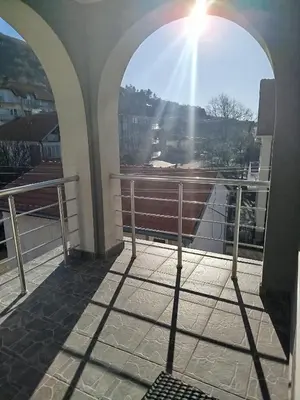 a sun shining through an archway on a balcony at VILA RUŽA - Grand apartman 2 in Soko Banja