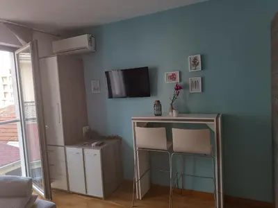 a room with a blue wall with a table and two chairs at Central Park in Niš