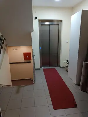 an office hallway with a red carpet and a door at Central Park in Niš