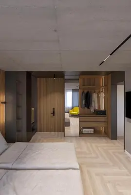 a large bedroom with a bed and a tv at Open Space in Niš
