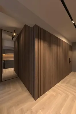 a large wooden wall in a room with wood floors at Open Space in Niš