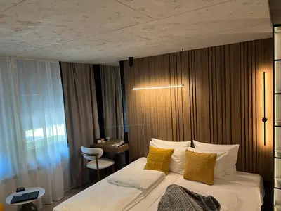 a bedroom with a bed with yellow pillows and a desk at Open Space in Niš