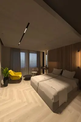 a bedroom with a large bed and a yellow chair at Open Space in Niš
