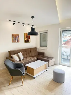 a living room with a couch and a coffee table at Cvetkovic apartman in Soko Banja