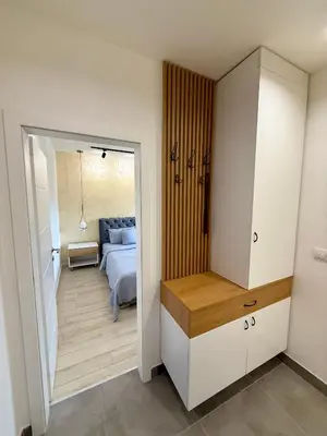 a bedroom with a bed and a door leading into a room at Cvetkovic apartman in Soko Banja