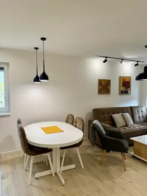 a living room with a table and a couch at Cvetkovic apartman in Soko Banja