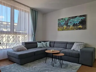 a living room with a couch and a table at President kop APP Katarina II free wellnes&spa in Kopaonik