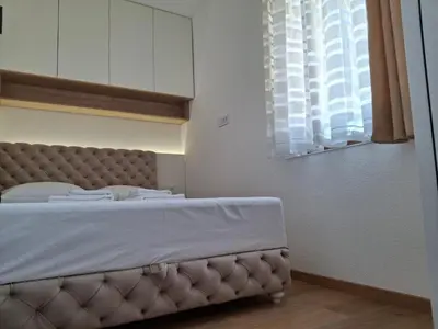 a bedroom with a large bed with a window at President kop APP Katarina II free wellnes&spa in Kopaonik