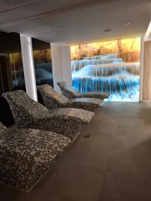 a row of chairs in a room with a painting at President kop APP Katarina II free wellnes&spa in Kopaonik