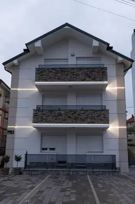 a building with balconies on the side of it at BOŽUR apartmani, kod hotela Sunce in Soko Banja