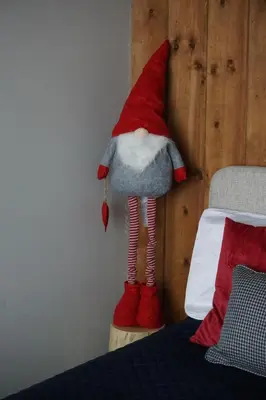 a stuffed mushroom toy is next to a bed at NOOK Kopaonik Luxury Apart & House in Kopaonik