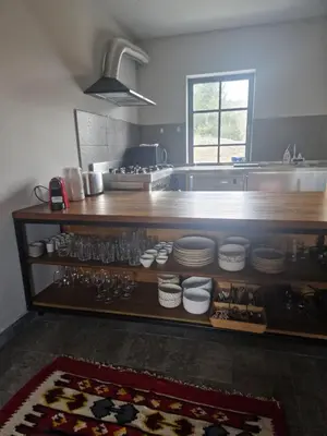 a kitchen with a counter with plates and dishes at NOOK Kopaonik Luxury Apart & House in Kopaonik