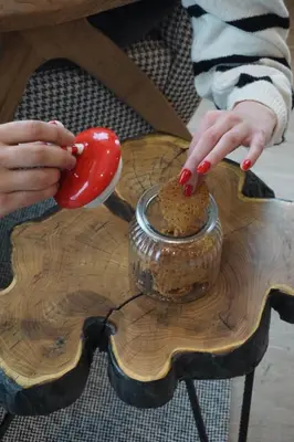 a person with red fingernauts hands holding a red spoon at NOOK Kopaonik Luxury Apart & House in Kopaonik