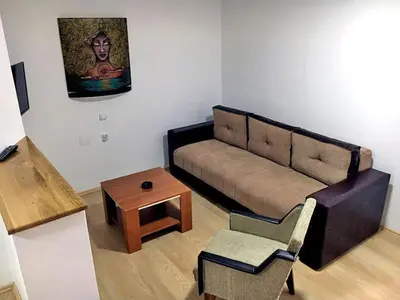 a living room with a couch and a table at Apartmani Vučić in Soko Banja