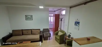 a living room with a couch and a table at Apartmani Vučić in Soko Banja