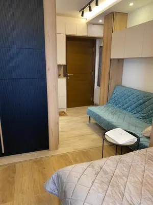 a bedroom with two beds and a door to a room at Magia Vido Apartment-President Kop A109 in Kopaonik