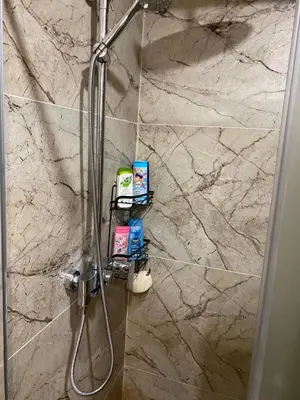 a bathroom with a shower with a marble wall at Magia Vido Apartment-President Kop A109 in Kopaonik