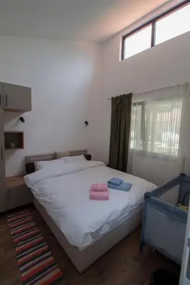 a bedroom with a bed with two towels on it at Apartmani 