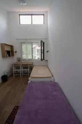 a bedroom with a bed in a room with a window at Apartmani 