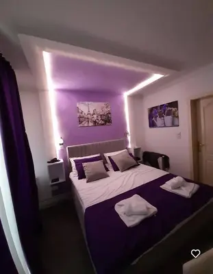 a bedroom with a large bed with two towels on it at Studio Sestica vila Lenka2 in Vrnjačka Banja