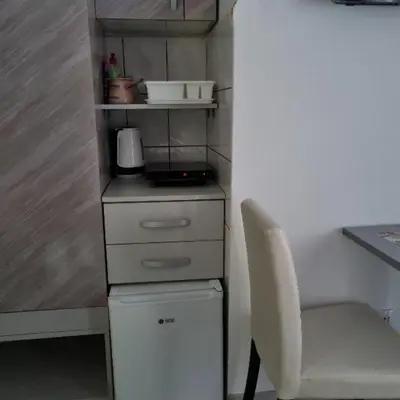 a small kitchen with a chair and a white dresser at Studio Sestica vila Lenka2 in Vrnjačka Banja
