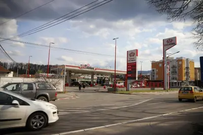 a gas station with cars parked in front of it at Apartman Aleksandra Vrnjacka Banja in Vrnjci