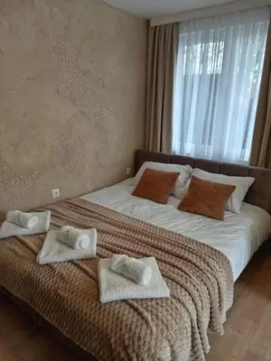 two beds with towels on them in a bedroom at Apartman Jež in Kuršumlija