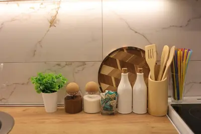 a counter with bottles and utensils on a counter top at Apartman Jež in Kuršumlija