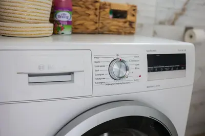 a white washing machine in a kitchen with a counter at Apartman Jež in Kuršumlija