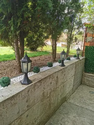a row of lights on a concrete retaining wall at Apartman Jež in Kuršumlija