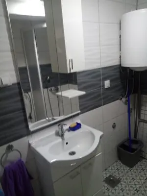 a bathroom with a sink and a mirror at Apartman Petrovic in Vrnjačka Banja