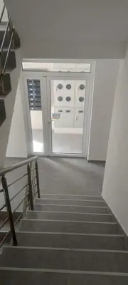 a stairway with a glass door and a stair case at Apartman Ivana in Soko Banja