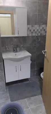a bathroom with a white sink and a toilet at Apartman Ivana in Soko Banja